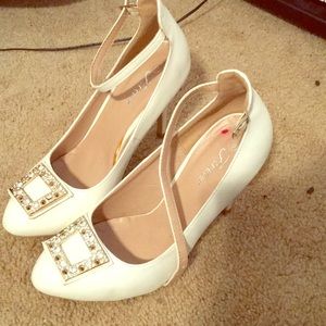 White heels with a jewel covered square on toes